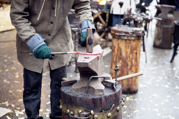 Blacksmith doing smithing in an open forge outdooes