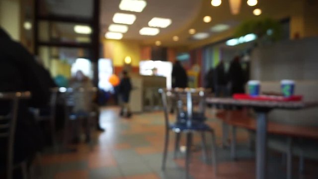 Defocused cafe or fast food or restaurant interior with people, blurred bokeh background