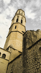 Fototapeta na wymiar Church of St. Peter in Figueres - Catalonia Spain. Gothic tower with dramatic clouds in the background