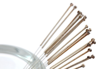 Silver needle acupuncture on an isolated white background. Close-up.