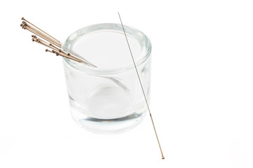 Silver needle acupuncture on an isolated white background. Close-up. - obrazy, fototapety, plakaty