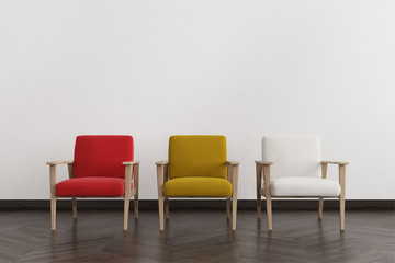 Red, white and yellow armchairs in an empty room