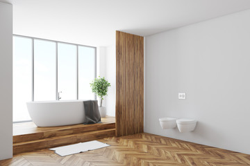 White bathroom corner, tub and toilets