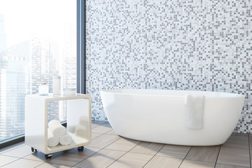 Gray tile bathroom corner, white tub