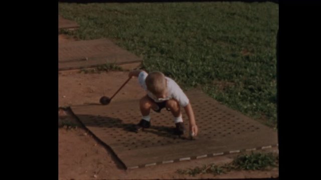 Little boy tees off at Golf Driving Range 1956