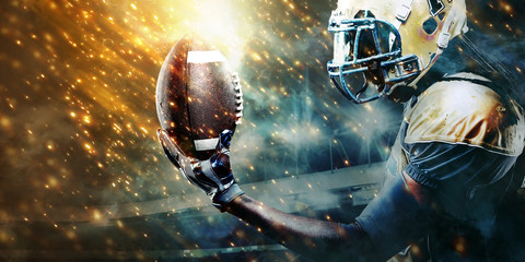 American football sportsman player on stadium running in action. Sport wallpaper with copyspace.