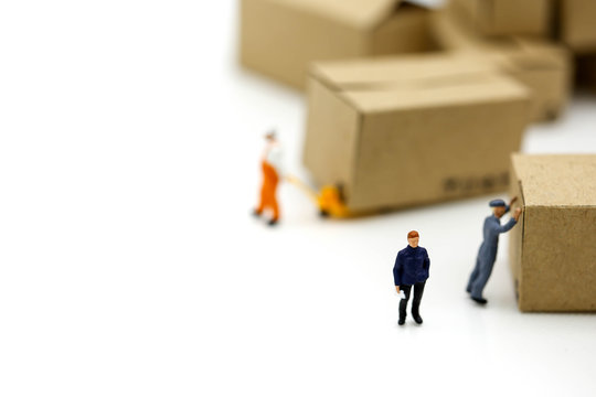 Miniature people: Worker and box with copy space using as background shipping, rent container, business concept.