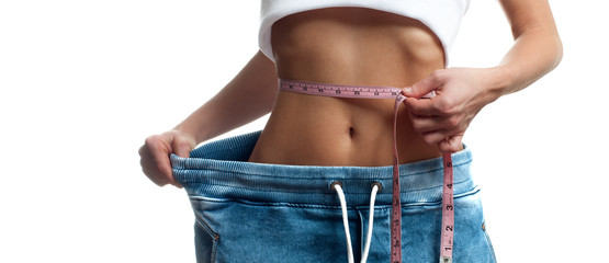 Woman is measuring waist after weight loss,. Diet concept