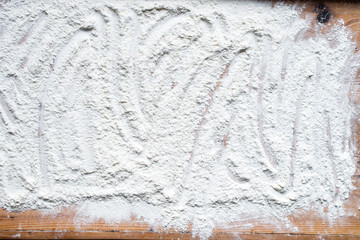 Old wooden board with flour. Background. Photo.