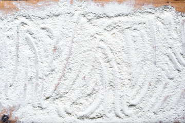 Flour on a wooden background