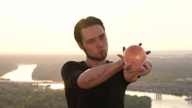 Guy-contact juggler shows his fantastic skills of balance and control of the body