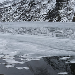 Fototapeta premium Reflection of mountain with ice floe floating on water, Lofoten, Nordland, Norway