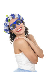 Black girl is half-profile and smiling. She is wearing a wreath on her head and sunglasses. Concept of freshness, vacation, travel, tropical climate..