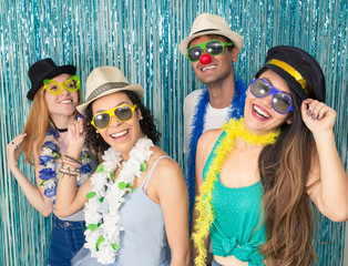 Partygoers are celebrating Carnival in Brazil. People are happy and smiling..