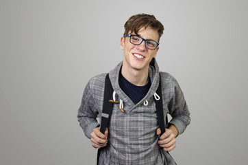 Teenager with backpack and eye glasses smiling and posing, education concept 