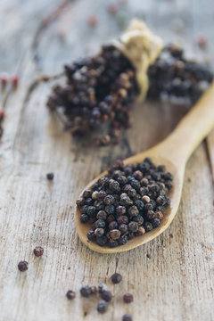 Black pepper on wood spoon ,spices for food.