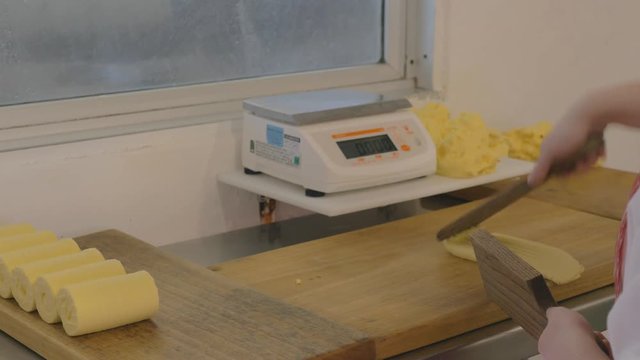 Making fresh butter inside factory by hand