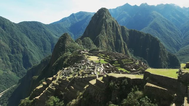 panning left shot of peru's famous lost inca city of machu picchu on a sunny morning