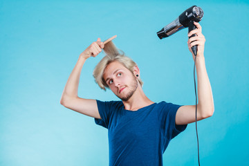 Trendy man with hair dryer