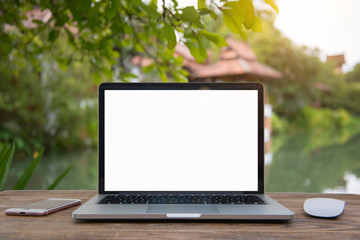 Outdoor office desk with laptop in the garden.Computer Laptop and tablet