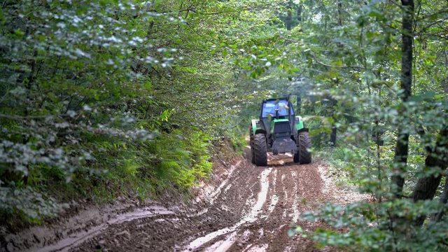 Tractor goes through forest path - (4K)