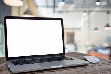 Laptop with blank screen on table of coffee shop blur background with bokeh.