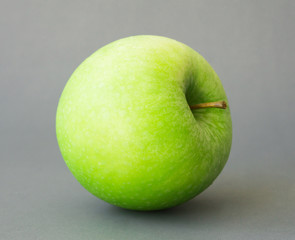 Green fresh apples fruit on grey background , healthy diet food concept