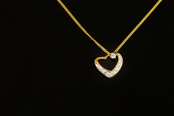 Fototapeta na wymiar gold necklace and heart shape pendant