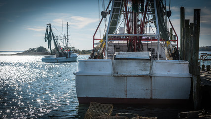 Fishing boats at dock with nets