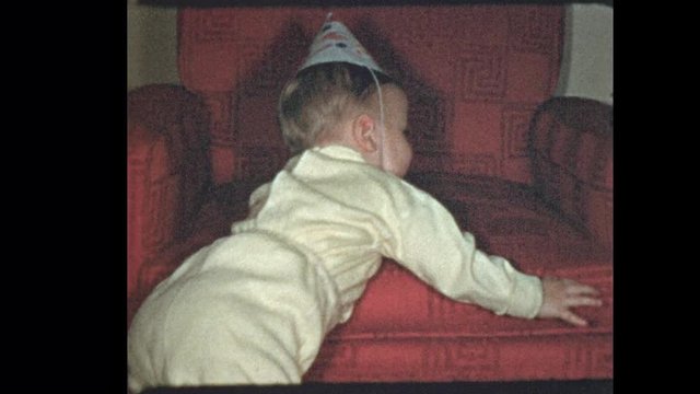1953 Happy 1 year old baby boy in birthday hat with antique wooden duck toy