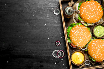 Burgers on an old tray.