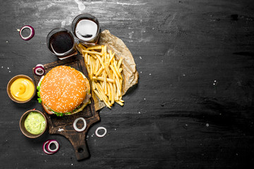 Street food. Fresh burger with cola, fries and sauces.