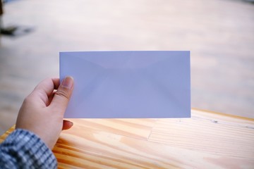 Woman hand hold the empty Envelope Letter Communication.