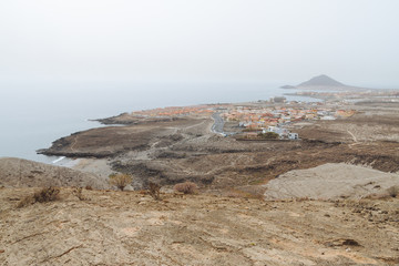 City in desert country near ocean in haze weather