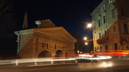 Fototapeta na wymiar Bergamo, the old city. One of the beautiful town in Italy. Lombardy. Landscape on the old gate named San Giacomo door during the evening with trails of headlights