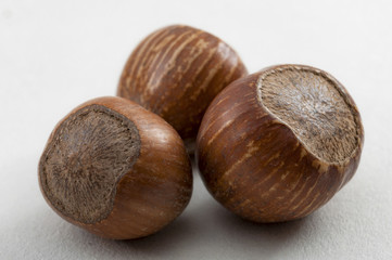 Natural healthy foods, organic nuts and vegan diet concept with close up on a bunch hazelnuts still in shell isolated on white background