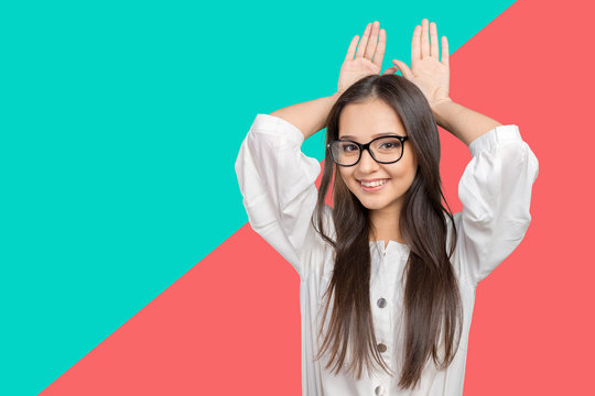 Happy Woman Showing Rabbit Ears With Her Palms