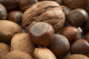 Natural foods and vegan diet concept with macro closeup on  mixed nuts still in shells