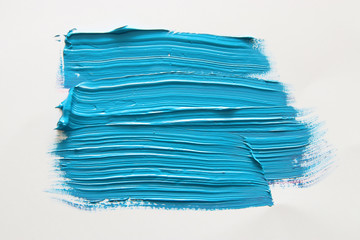 Blue watercolor brush stroke over white background.