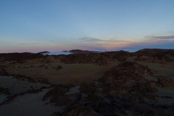 Fototapeta na wymiar Desert landscape with sunset light on mountains in background