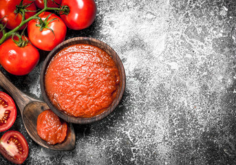 Tomato sauce in a wooden bowl.
