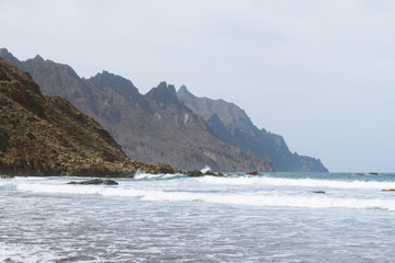 Remote sand beach in volcanic landscape in summer