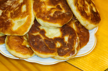 Russian pirozhki, fresh fried pasties stuffed with potatoes