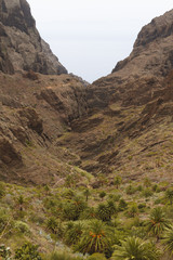 Small village deep in mountains with steep cliffs around
