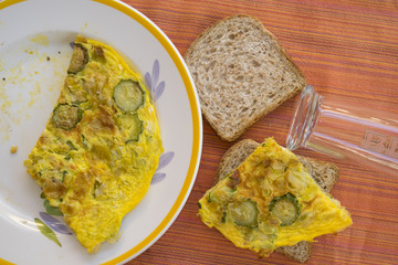 preparing a sandwich with zucchini omelette