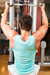 Naklejka premium Young Body-builder At The Gym
