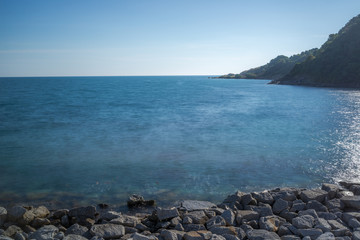 Sea wave impact with rock streak like a boil water with clear sky, Khao Leam Ya National Park at Rayong of Thailand (Long Exposure Technique photograph)