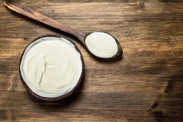 Fototapeta na wymiar Natural yogurt in a bowl with a spoon.