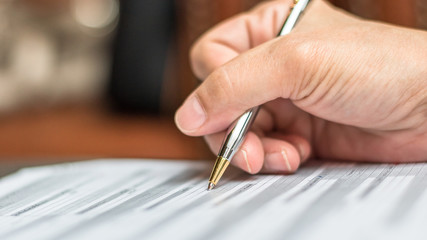 Administrator's hand fill in business schedule form document writing on yearly work plan, monthly...