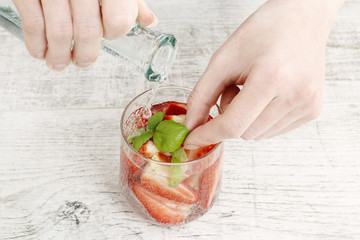 Woman preparing strawberry lemonade